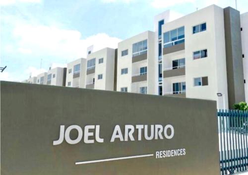 a jell arthur sign in front of a building at Acogedor apartment , seguridad las 24 horas , Cibao International Airport 8 minutos, Centro de Santiago 10 Minutos , Tamboril la capital mundial del cigarro 10 minutos in Licey al Medio