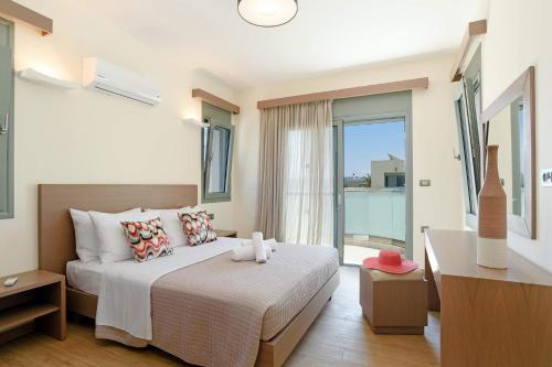 a bedroom with a bed and a large window at Villa Paleos Hillside by Villa Plus in Ialysos