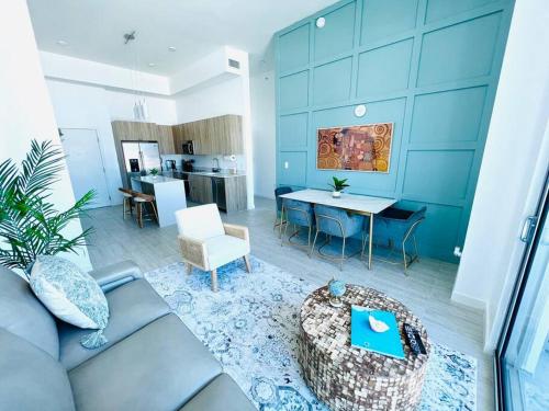 a living room with a couch and a table at Sleek 2BD 2BA Condo In Miami Design District in Miami