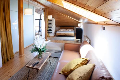 a living room with a couch and a bed at Apartmány Mind Adventure in Lštění