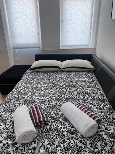 a bed with two pillows and a book on it at Galeb Apartment Ohrid in Ohrid