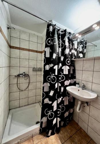 a bathroom with a shower curtain and a sink at Central Single Room Ground floor in Heraklio