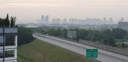 a highway with a city in the background at BSP21 Family Homestay in Jenjarum