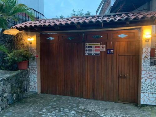 a wooden garage door with a sign on it at Hotel Puerto Villamar in Tepoztlán