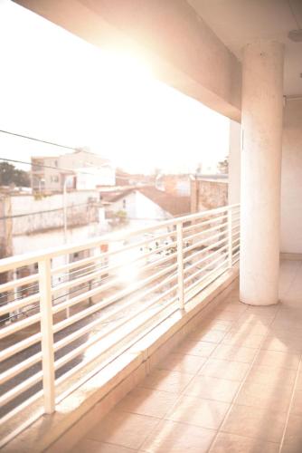 a balcony with a white railing and a view of a city at Nice Alem in Tandil