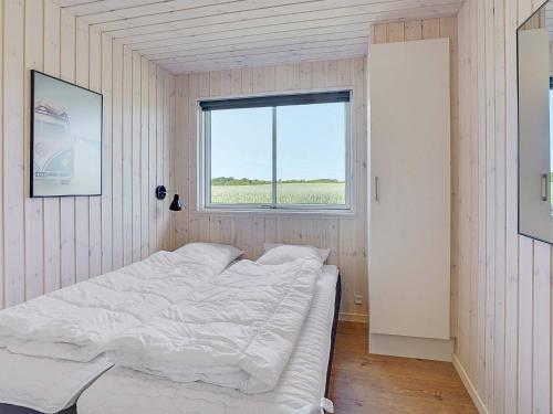 a white bed in a room with a window at Luxury Retreat by Limfjorden - By Traum Ferienwohnungen in Spottrup