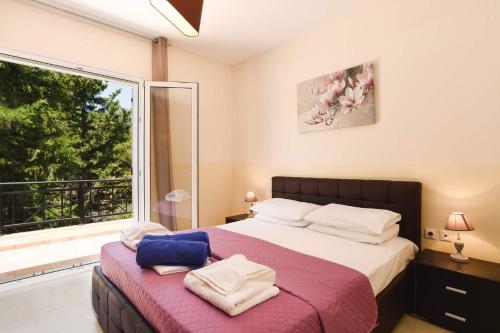 A bed or beds in a room at Villa Olympios Springs by Villa Plus