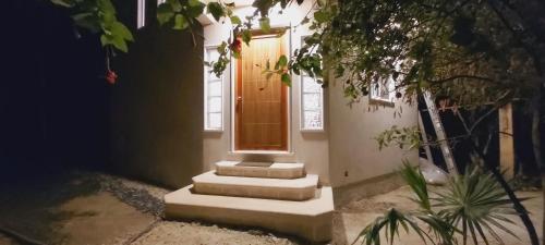 a house with stairs leading up to a door at NEW! CASA XOLA Cenote and Fauna Loft in Cozumel