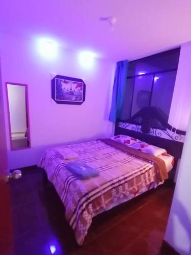 a bedroom with a bed in a purple room at B1-Departamento Bolognesi in Chiclayo
