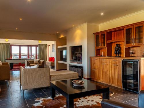 a living room with a couch and a table at Rooilande Guest Farm Guest House in Laingsburg