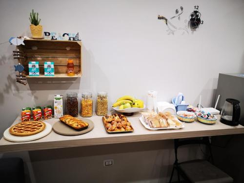 a table with plates of food on top of it at B&B Tonnarella Beach in Torre Forte