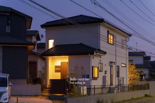 a house with a sign on the front of it at Maple House - Vacation STAY 85725 in Fukuoka