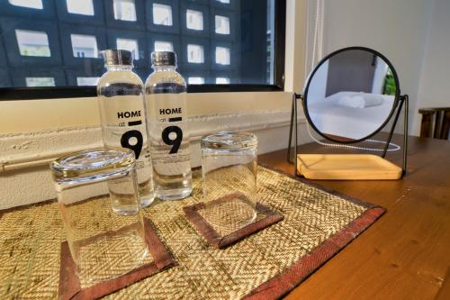 two bottles of water and two glasses on a table at Home at 9 in Ban Klang (4)