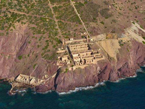 an aerial view of a building on a cliff at Hotel Don Pedro in Portoscuso