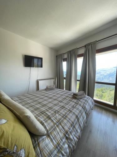 a bedroom with a bed and a large window at JUPILUC-PILA Studio 56 CIR 0064 in Pila
