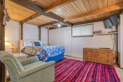 a bedroom with a bed and a tv and a couch at Oceania House in Waldport