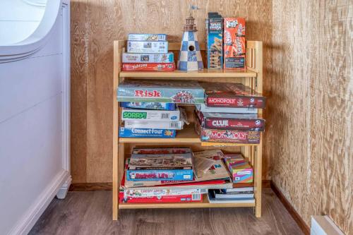 a book shelf filled with lots of books at Oceania House in Waldport
