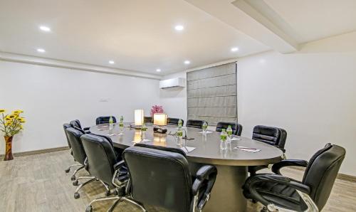 a conference room with a large table and chairs at Treebo Ahinsa Residency Sohna Road in Gurgaon