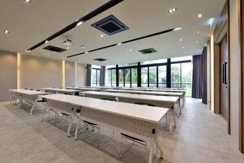 a cafeteria with tables and chairs and windows at The Chill at Krabi Hotel in Krabi town