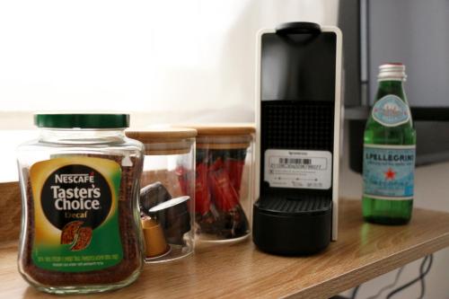 a counter with a bottle of ketchup and a bottle of condiments at Paris Square Apartments Downtown in Haifa