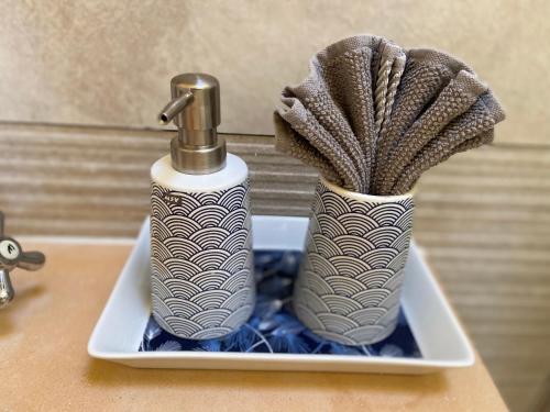 two toothbrushes in vases on a bathroom sink at Finca Sa Canova Agroturismo in Campos
