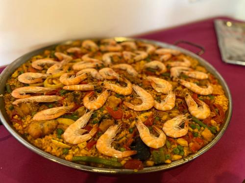 a pan filled with shrimp and vegetables on a table at Finca Sa Canova Agroturismo in Campos