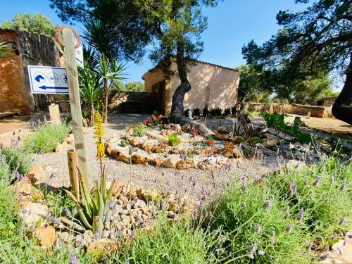 a garden with rocks in front of a building at Finca Sa Canova Agroturismo in Campos