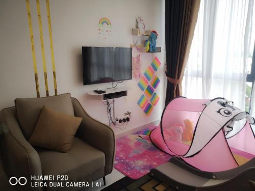 a living room with a couch and a tv at Ammar @ Troika in Kota Bharu