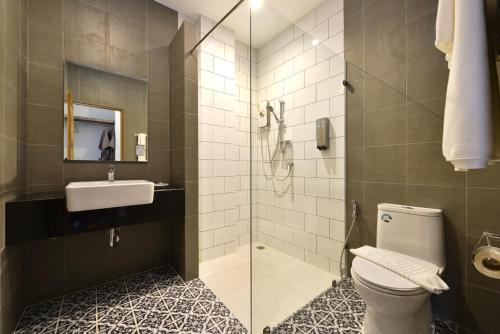 a bathroom with a toilet and a sink and a shower at The Chill at Krabi Hotel in Krabi town