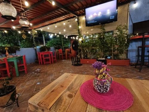 a table with a vase of flowers on top of it at Posada Casa Mexicana Jamaica in Mexico City