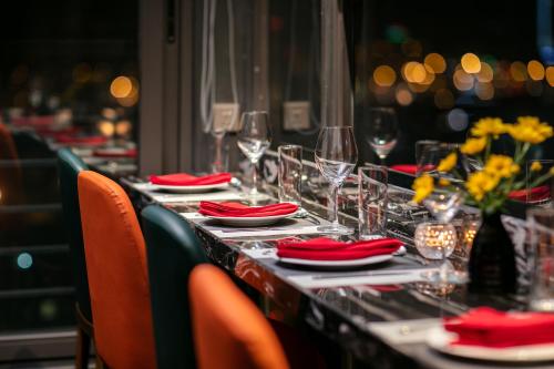 a long table with red napkins and wine glasses at Bendecir Hotel & Spa in Hanoi