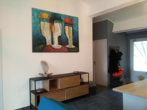 a living room with a painting on the wall at Edith et Jean-Paul in Porto-Vecchio