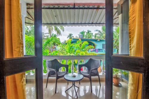 a view from the balcony of a room with a table and chairs at Villa Verediana in Candolim