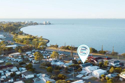 an aerial view of a parking lot next to the water at Beachhouse Bed and Breakfast in Redcliffe
