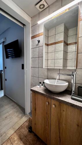 a bathroom with a sink and a mirror at Central Double Room Ground floor in Heraklio