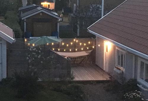 a deck with an umbrella and a table with lights at Hatty's Guesthouse in Motala