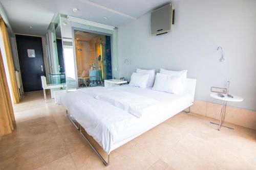 a large white bed in a room with a television at Venn Boutique Hotel in Samsun