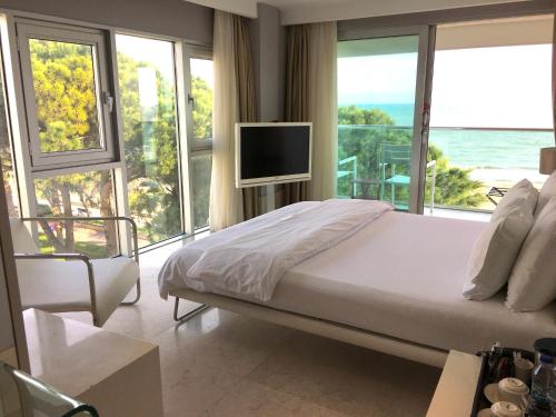 a bedroom with a bed and a tv and windows at Venn Boutique Hotel in Samsun