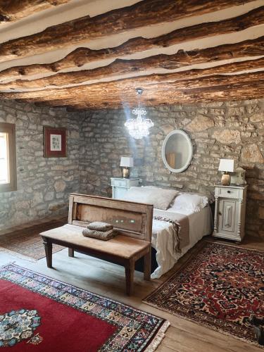a bedroom with a bed in a stone wall at Masiadenjust in Rojals