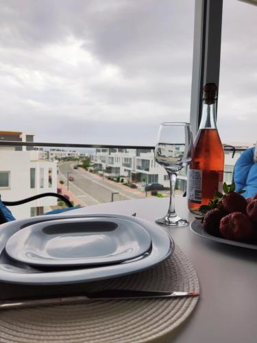 a table with a plate and a glass of wine at Your Four Seasons in Boğaz