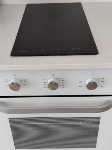 a stove with a laptop on top of it at Your Four Seasons in Boğaz
