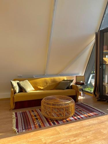 a living room with a couch and a rug at Sno Cottage in Sno