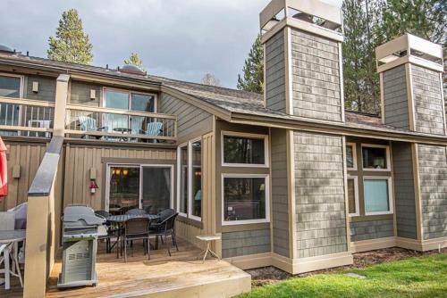 a house with a patio and a table and chairs at Quelah 21 - Meredith Lodging in Sunriver