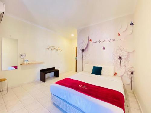 a bedroom with a bed and a writing on the wall at Perdana Serviced Apartment & Resorts in Kampung Padang Masirat