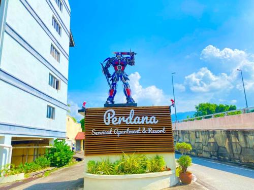 a sign for a hotel with a statue on top of it at Perdana Serviced Apartment & Resorts in Kampung Padang Masirat