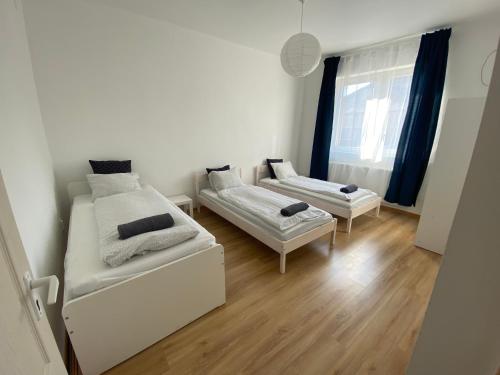 a living room with two beds and a couch at Budapest Airport-Vecsés Trainstation Apartman K7 in Vecsés