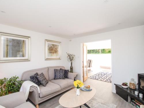a living room with a couch and a table at Lobster Lookout in Swanage