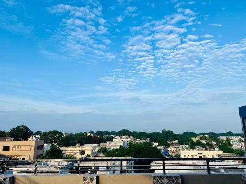 a view of a city under a blue sky with clouds at V Homestays in Bhadrāchalam