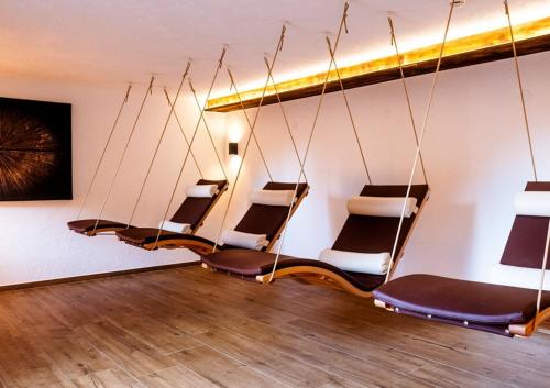 a row of chairs in a room with wooden floors at Hotel Edelweiss in Kaunertal