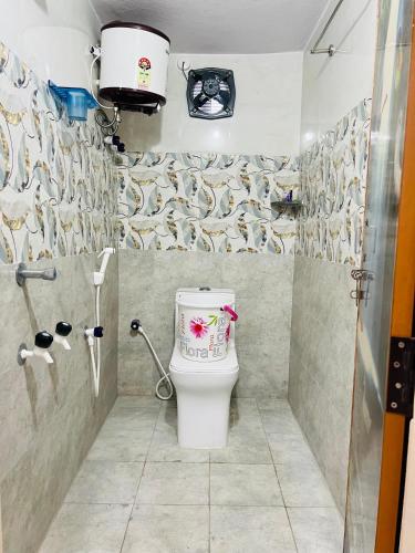 a bathroom with a toilet in a shower at V Homestays in Bhadrāchalam